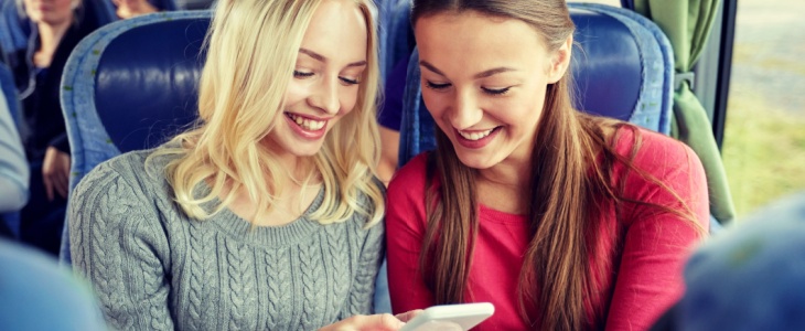 two girls watch a funny video on a cell phone