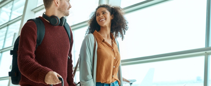 a man and woman walk through the airport together