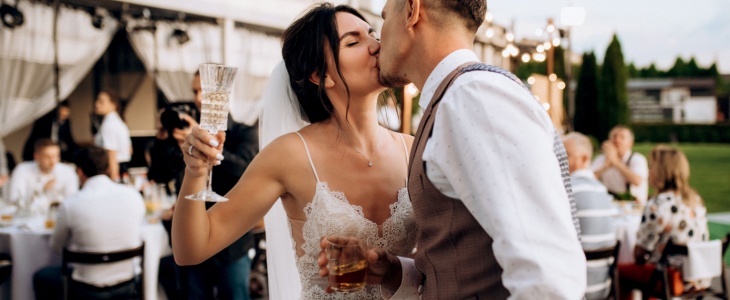 a bride and groom share a kiss at their reception